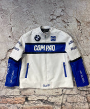 White jacket with blue accents and branding on a textured stone wall background