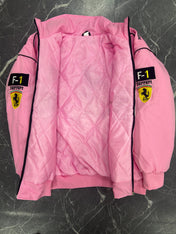 Pink quilted jacket with Ferrari logos on a dark textured surface