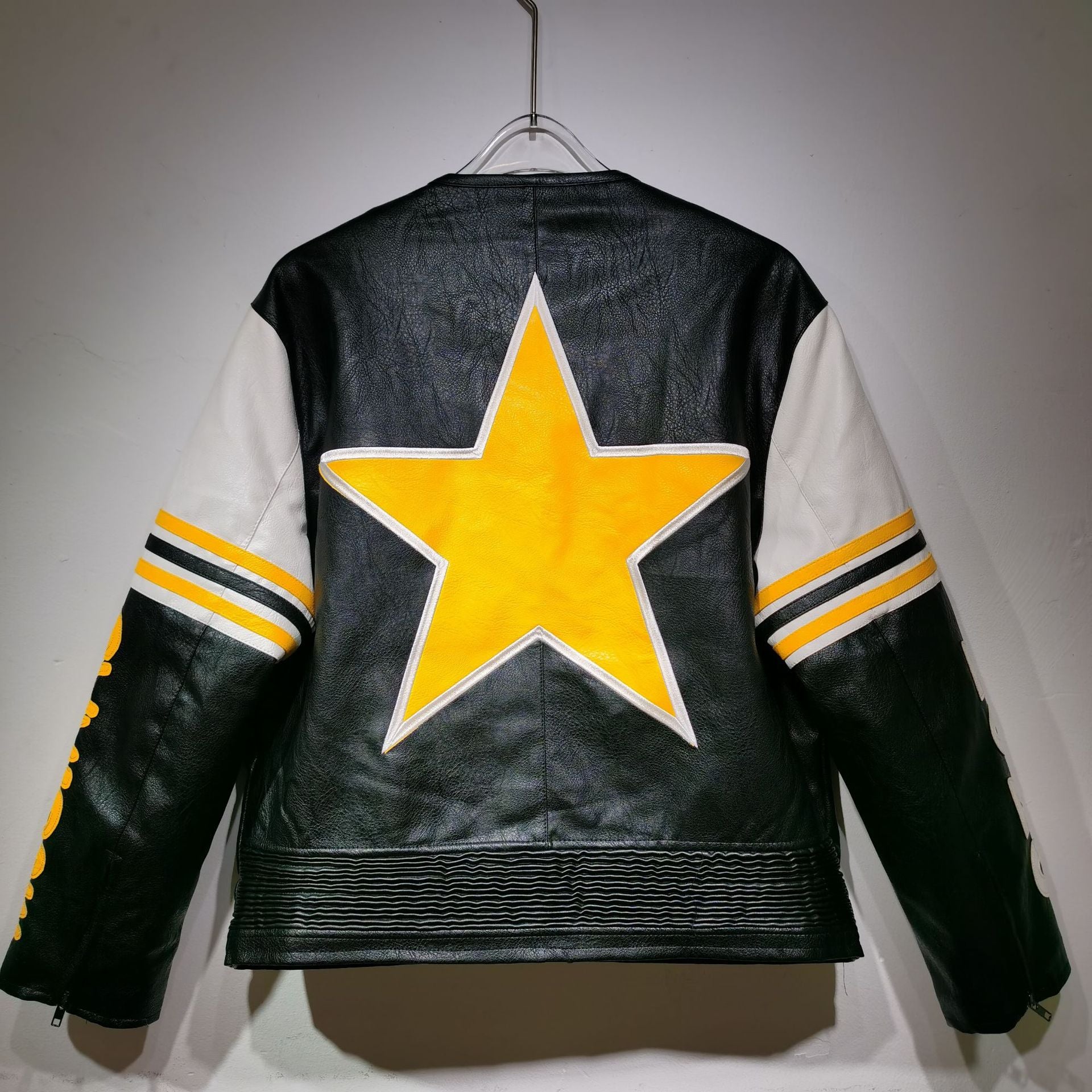 Black leather jacket with a yellow star on a gray background