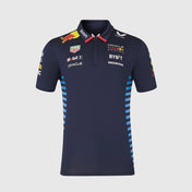 Navy blue polo shirt with various brand logos on a light gray background
